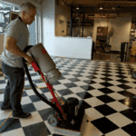 Man cleaning a tile black and white checkered floor